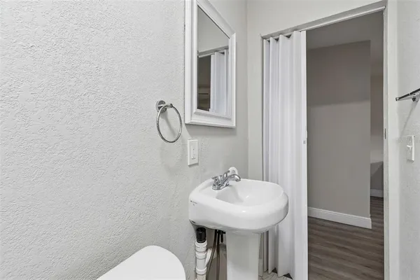 a kitchen with a refrigerator stove and white cabinets