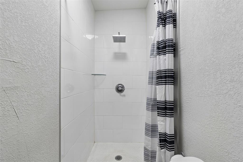 7403 Spring Court Tampa, FL 33634 - Photo 41 of 100 a bathroom with a shower and a sink