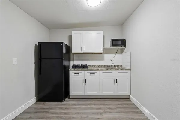 a bathroom with a sink and mirror with toilet