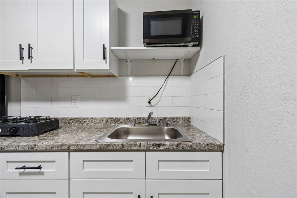7403 Spring Court Tampa, FL 33634 - Photo 45 of 100 a kitchen with granite countertop a sink and a stove