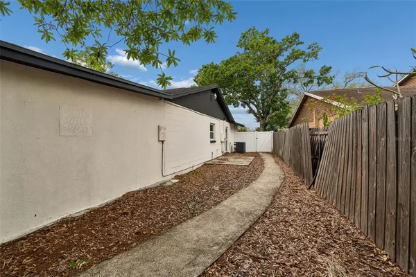a view of a grey house with a yard