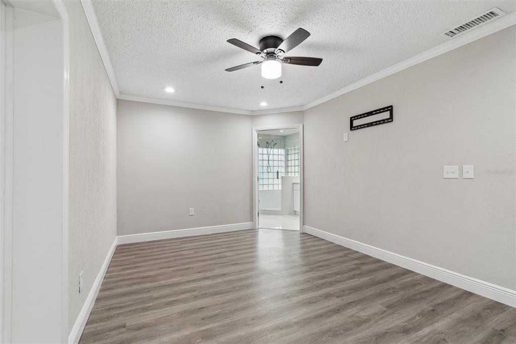7403 Spring Court Tampa, FL 33634 - Photo 62 of 100 an empty room with wooden floor and ceiling fan