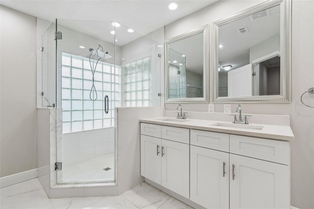 7403 Spring Court Tampa, FL 33634 - Photo 66 of 100 a bathroom with a shower sink and mirror