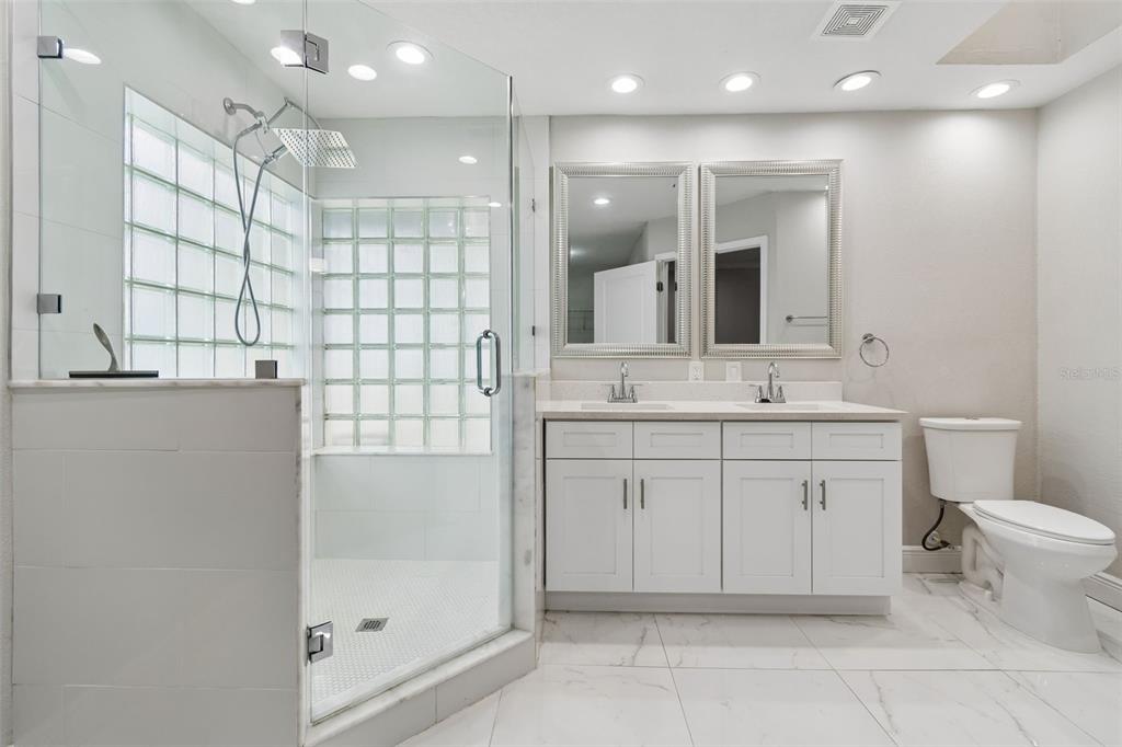 7403 Spring Court Tampa, FL 33634 - Photo 67 of 100 a bathroom with a sink a toilet and shower