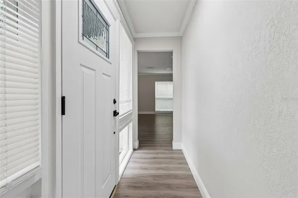 a view of an empty room with a fireplace and a window