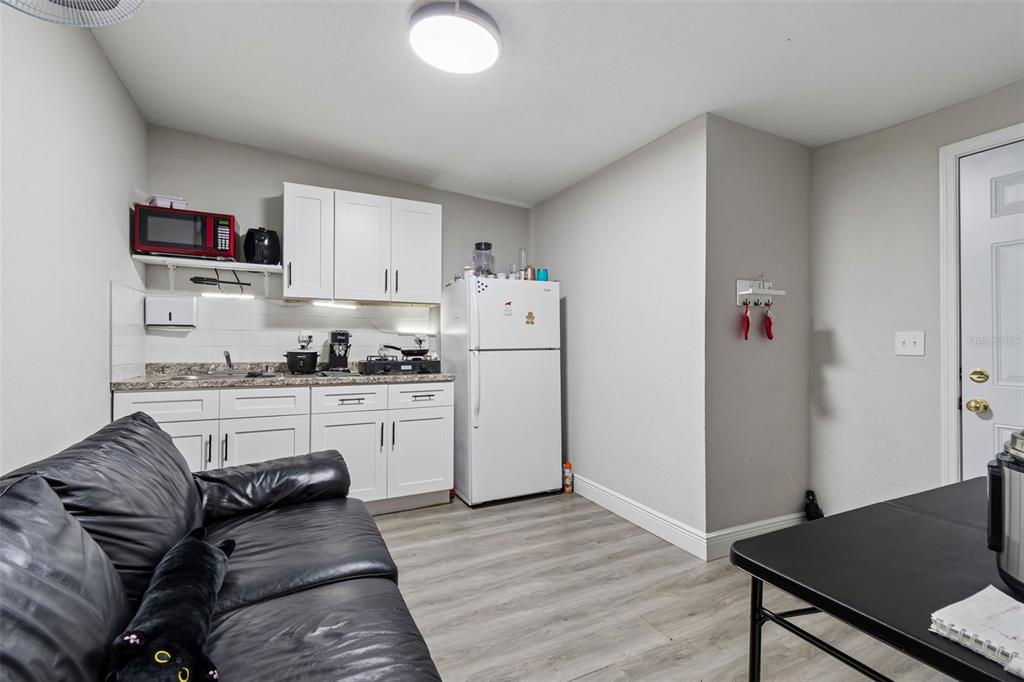 7403 Spring Court Tampa, FL 33634 - Photo 73 of 100 a kitchen with granite countertop white cabinets and white appliances