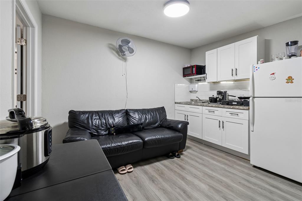 7403 Spring Court Tampa, FL 33634 - Photo 74 of 100 a kitchen with a refrigerator stove and white cabinets