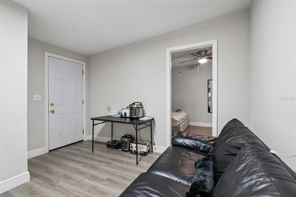 7403 Spring Court Tampa, FL 33634 - Photo 76 of 100 a living room with furniture and a wooden floor