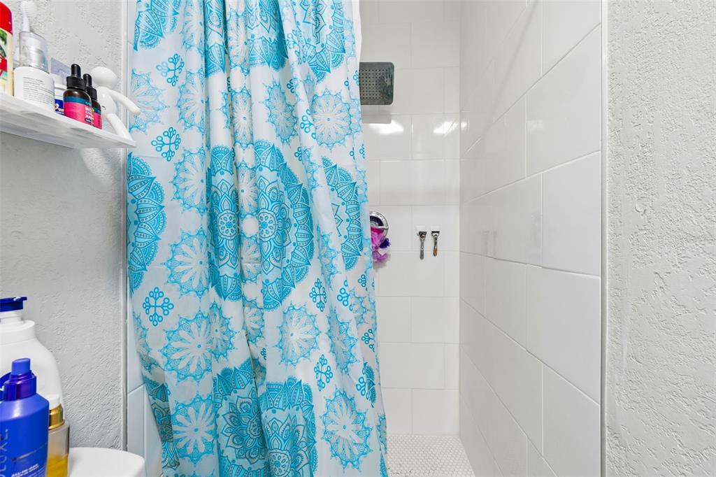 7403 Spring Court Tampa, FL 33634 - Photo 78 of 100 a bathroom with a shower curtain and a shower curtain
