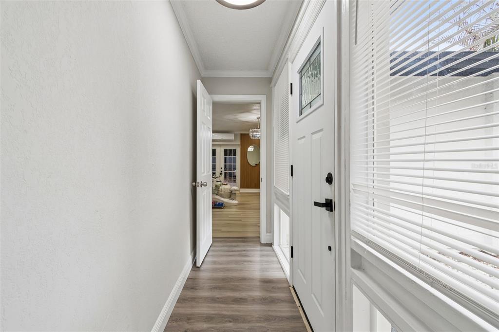 7403 Spring Court Tampa, FL 33634 - Photo 8 of 100 a view of a hallway with wooden floor and staircase
