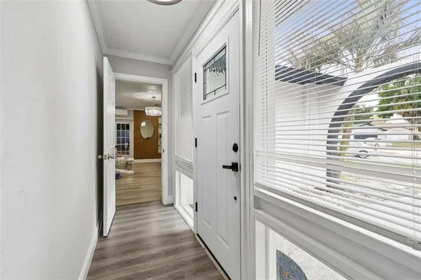 a view of a hallway with wooden floor and staircase