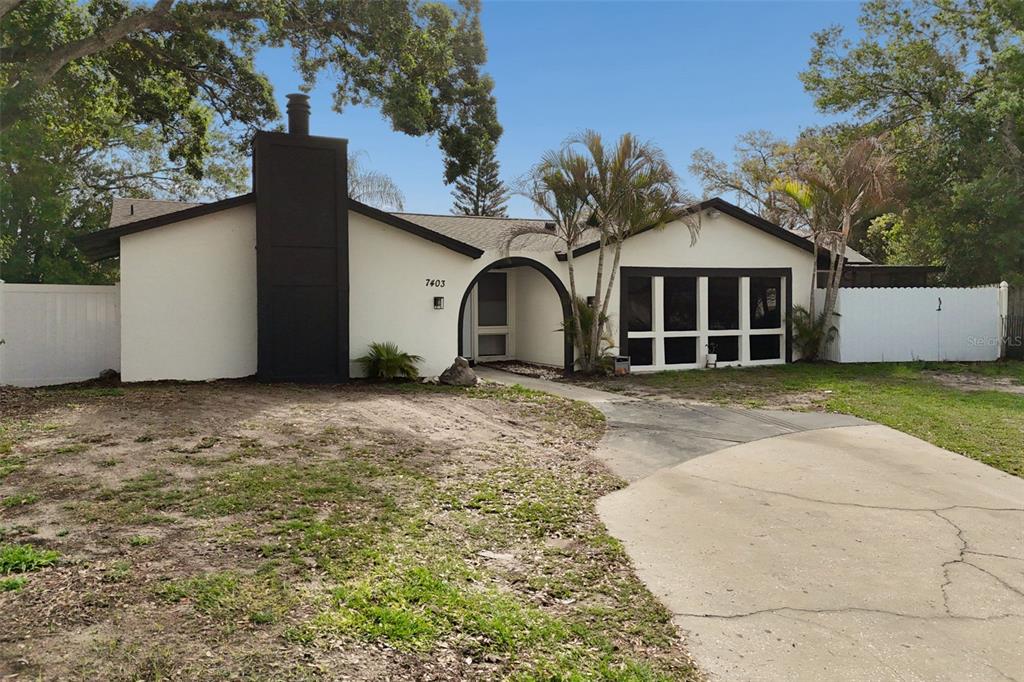 7403 Spring Court Tampa, FL 33634 - Photo 96 of 100 a view of a grey house with a yard