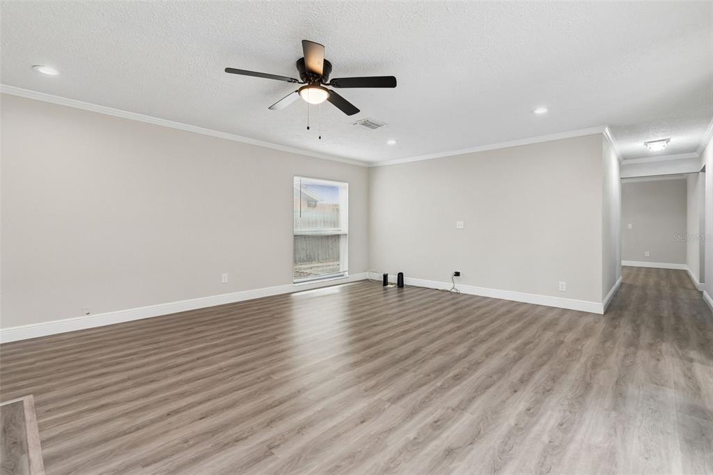 7403 Spring Court Tampa, FL 33634 - Photo 10 of 100 a view of empty room with wooden floor and ceiling fan