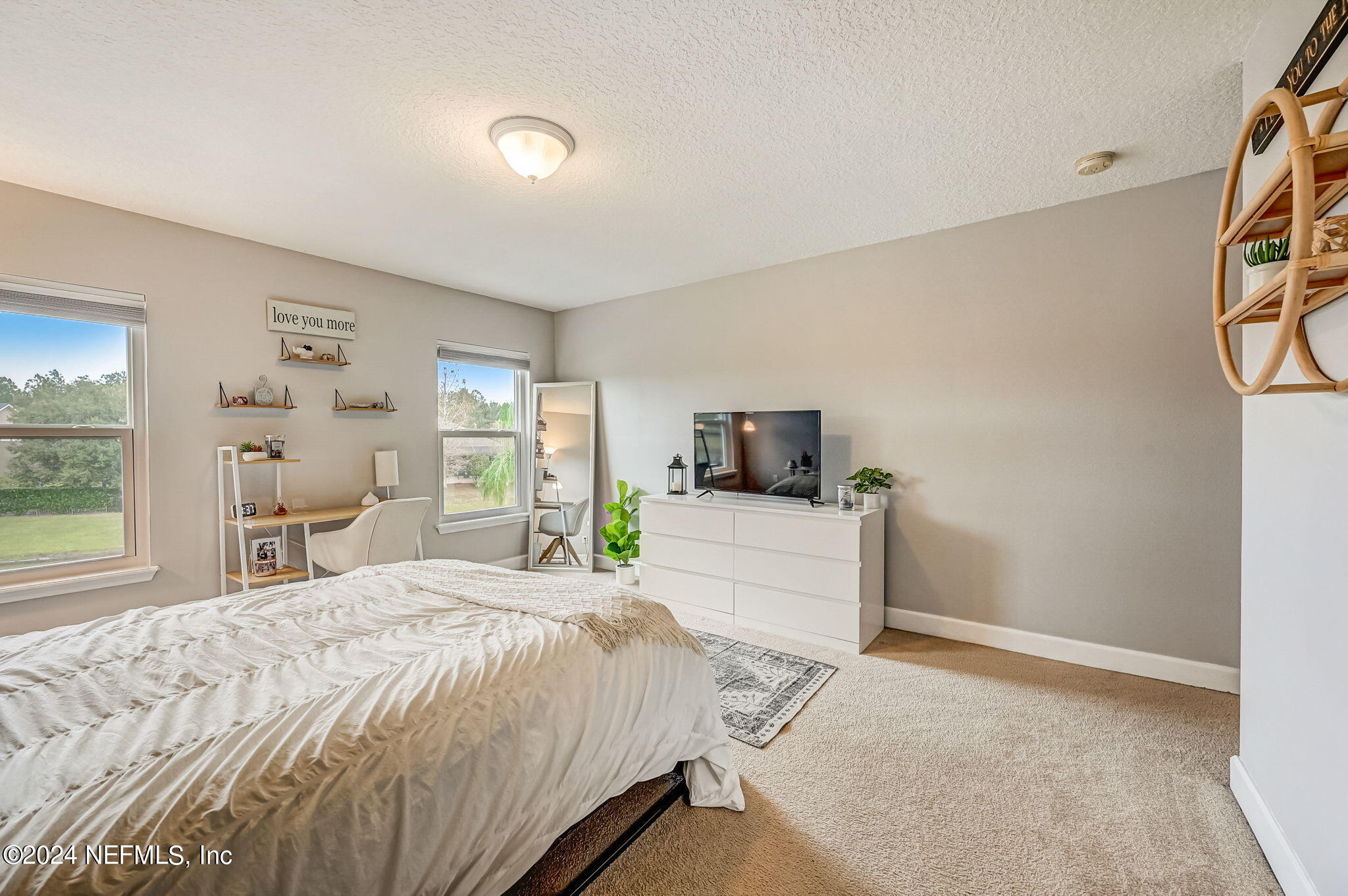 206 North Saxxon Road St. Augustine, FL 32092 - Photo 34 of 87 a bedroom with a large bed and a tv