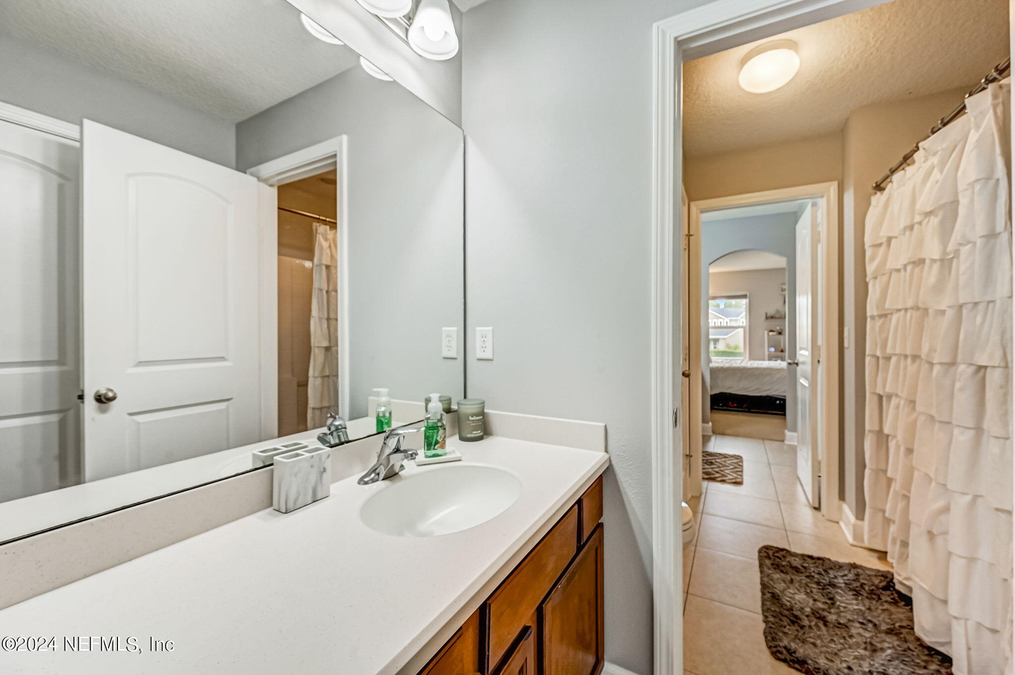 206 North Saxxon Road St. Augustine, FL 32092 - Photo 38 of 87 a bathroom with a sink and a mirror