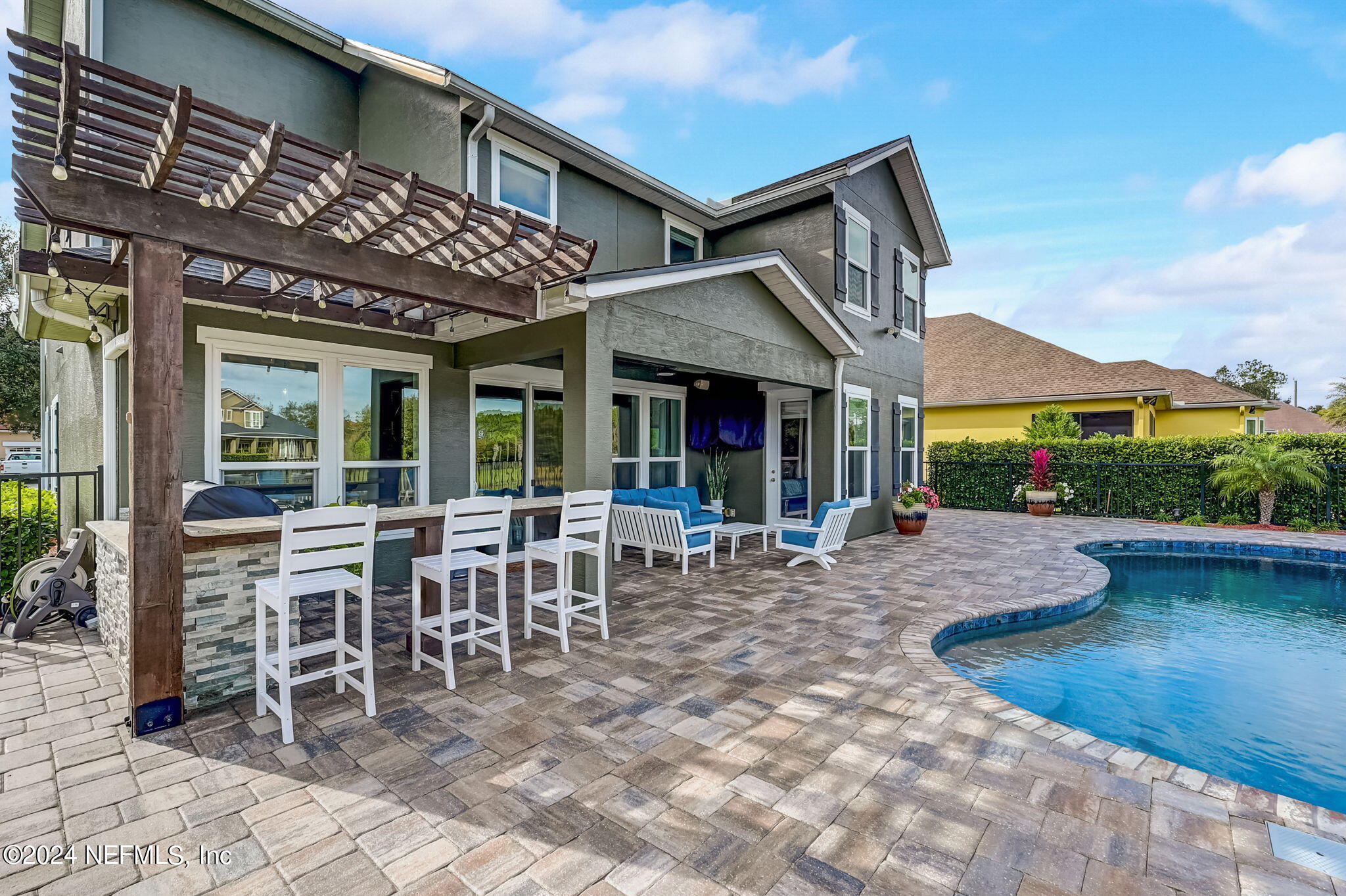 206 North Saxxon Road St. Augustine, FL 32092 - Photo 54 of 87 a view of a patio with table and chairs with wooden floor and fence