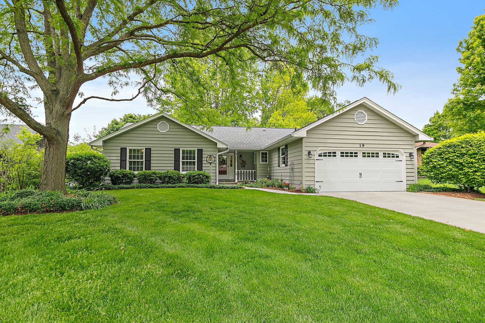 a front view of a house with a garden