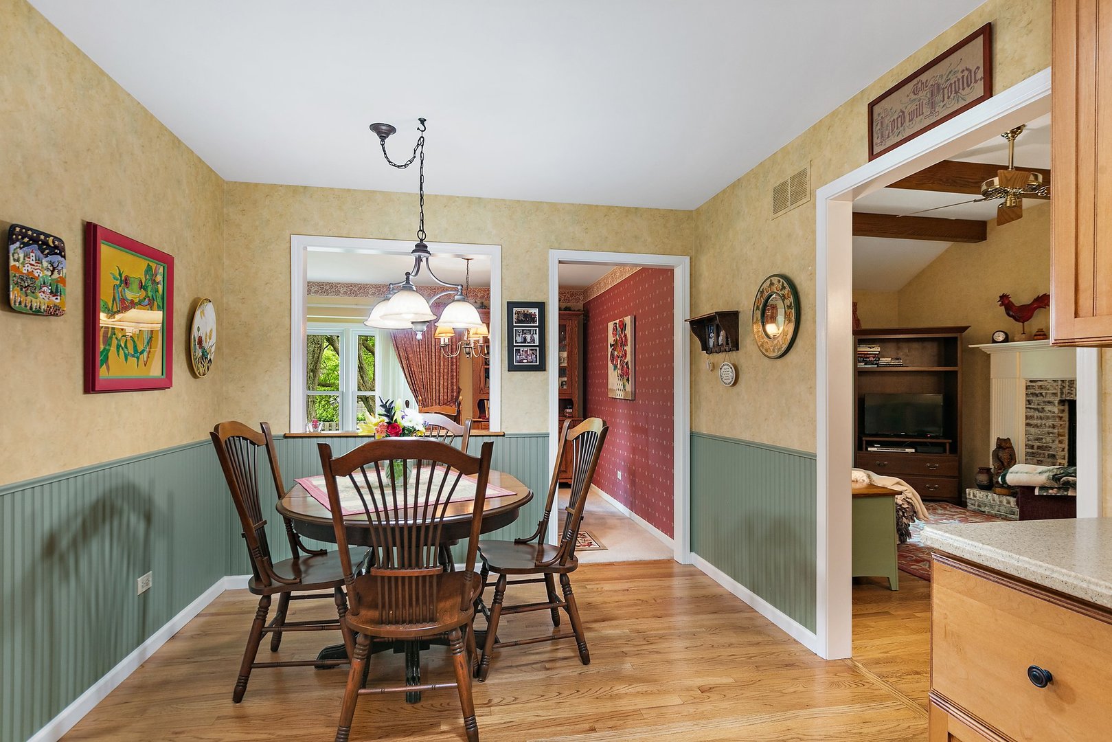 19 Green Ridge Road Elgin, IL 60120 - Photo 11 of 26 a dining room with furniture a chandelier and wooden floor