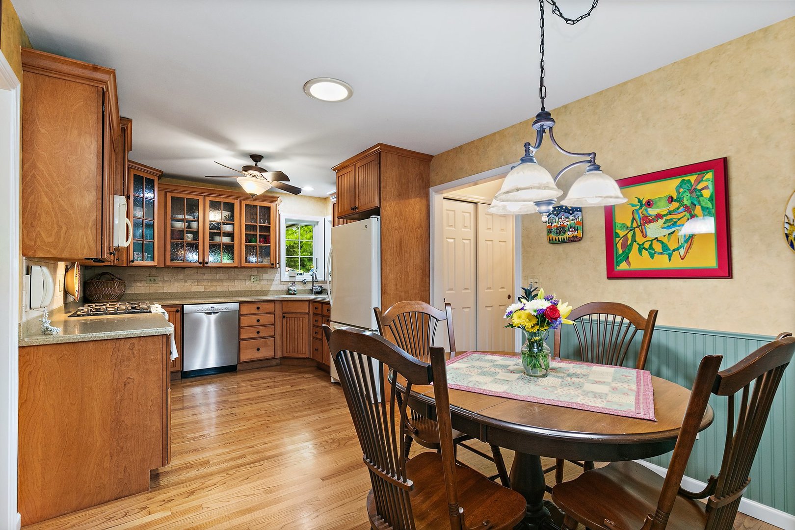 19 Green Ridge Road Elgin, IL 60120 - Photo 9 of 26 a dining room with furniture a chandelier and wooden floor
