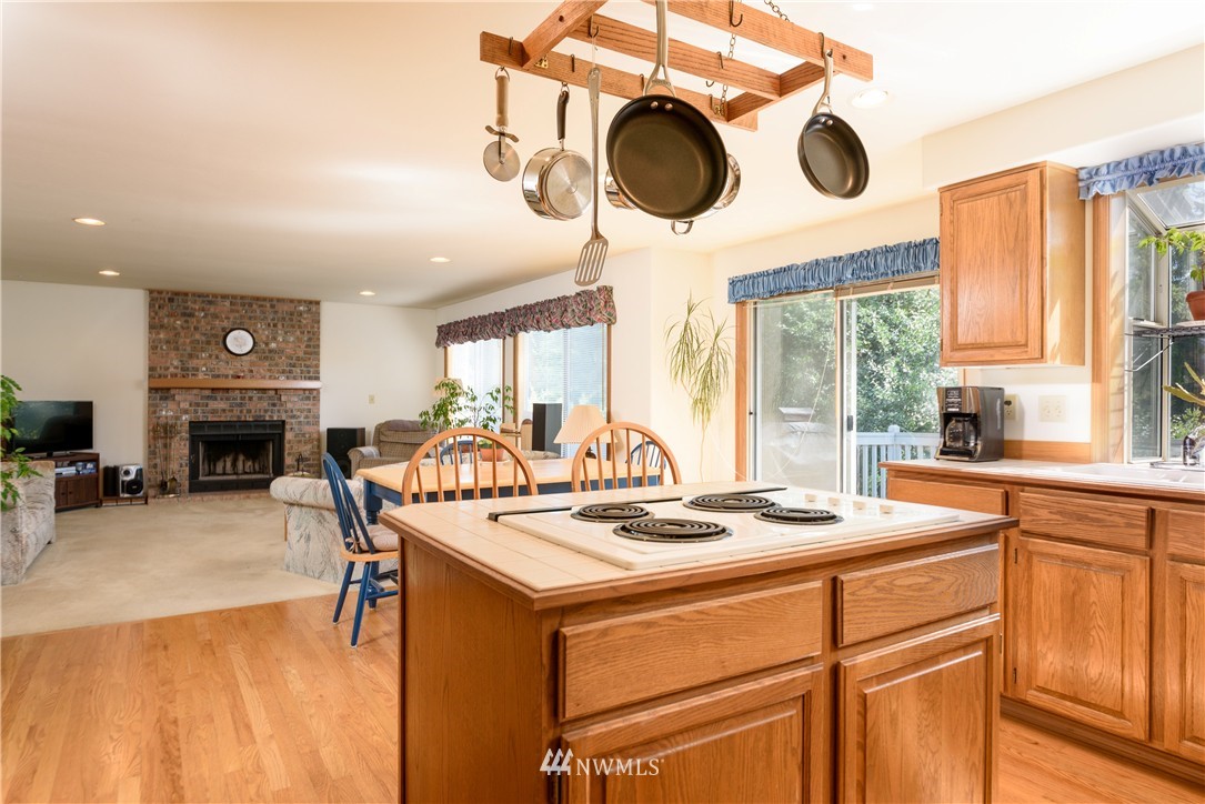 1610 Field Avenue Northeast Renton, WA 98059 - Photo 4 of 14 a kitchen with a stove a refrigerator and a fireplace