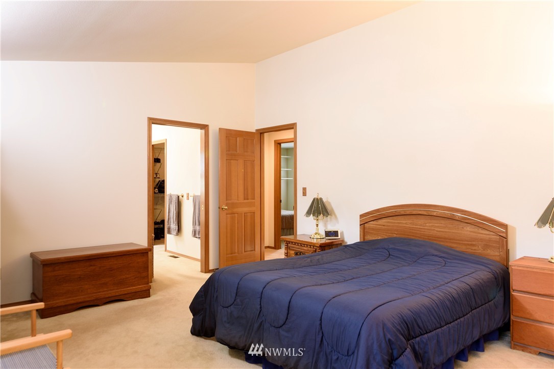1610 Field Avenue Northeast Renton, WA 98059 - Photo 9 of 14 a bedroom with a bed and a dresser with rug