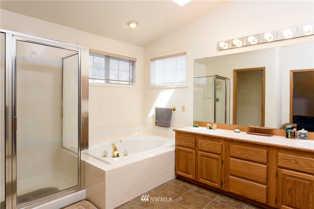 1610 Field Avenue Northeast Renton, WA 98059 - Photo 10 of 14 a bathroom with a tub sink and mirror