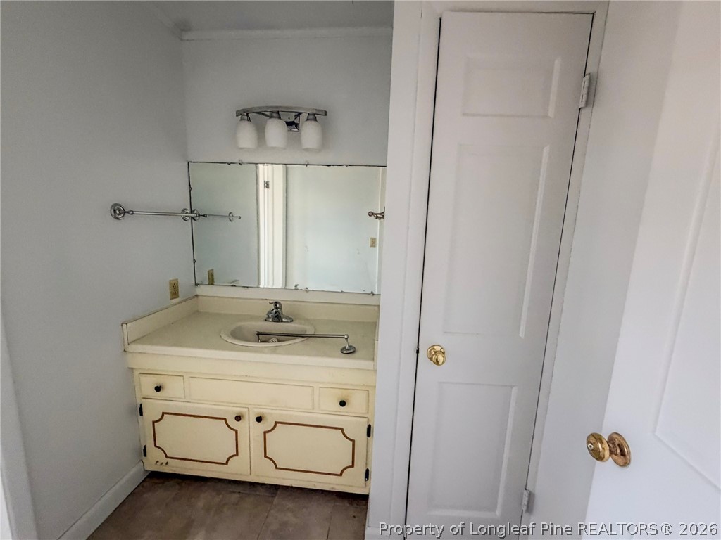 575 Veterans Road St. Pauls, NC 28384 - Photo 9 of 27 a bathroom with a sink and a mirror