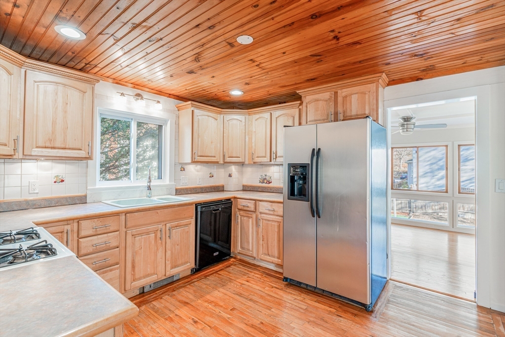 5 Sherbrook Place Lynn, MA 01904 - Photo 11 of 34 a kitchen with stainless steel appliances granite countertop a refrigerator a sink a stove and white cabinets with wooden floor