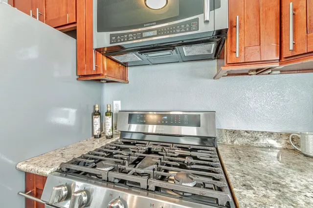 a stove top oven sitting inside of a kitchen