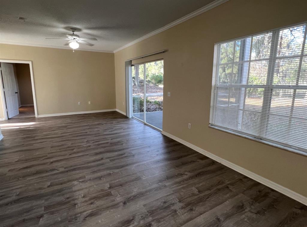 10000 Southwest 52nd Avenue, Unit U131 Gainesville, FL 32608 - Photo 5 of 15 a view of an empty room with wooden floor and a window