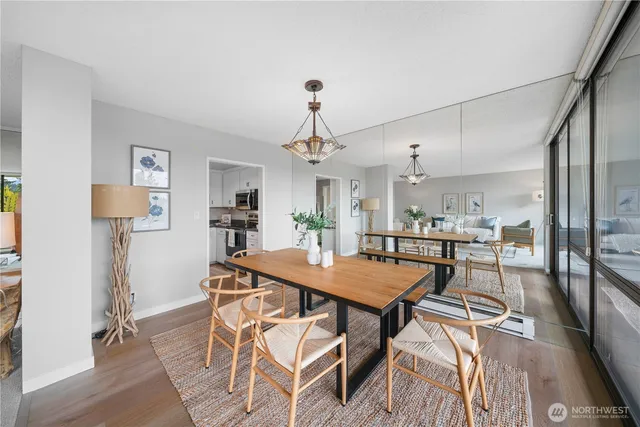 a living room with furniture a table and a large window