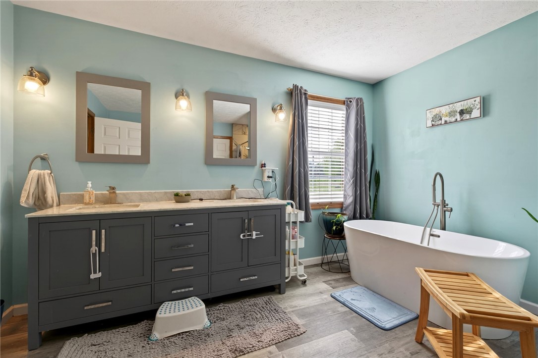4996 Shannon Avenue Springfield, OH 45504 - Photo 36 of 61 This tranquil bathroom provides a perfect retreat, featuring a spacious soaking tub and a double vanity.