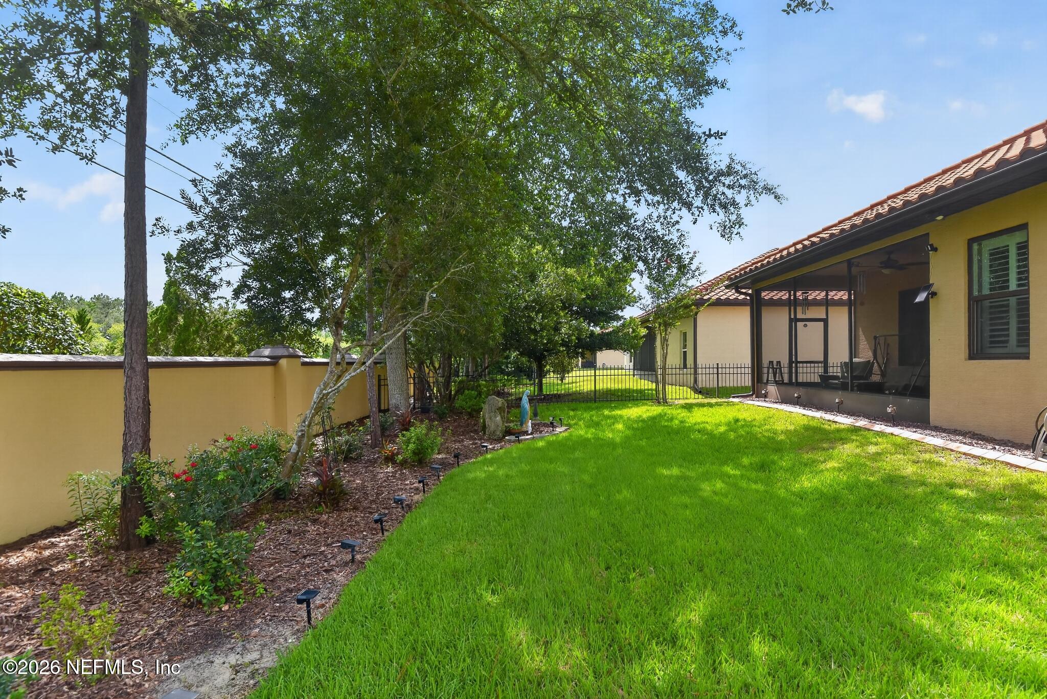 110 Vía Roma Ormond Beach, FL 32174 - Photo 5 of 43 a backyard of a house with lots of green space