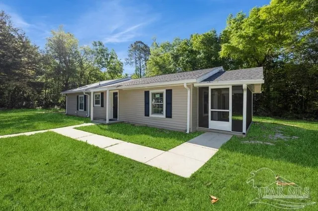 a view of a house with a yard and a garden