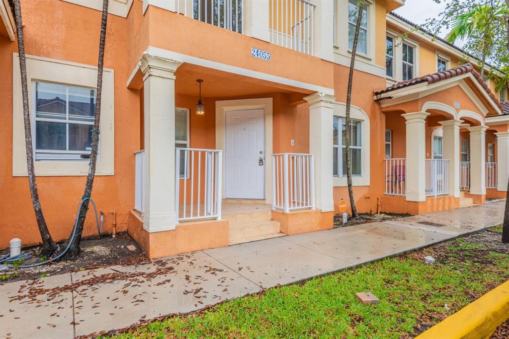 a backyard of a house with sofas