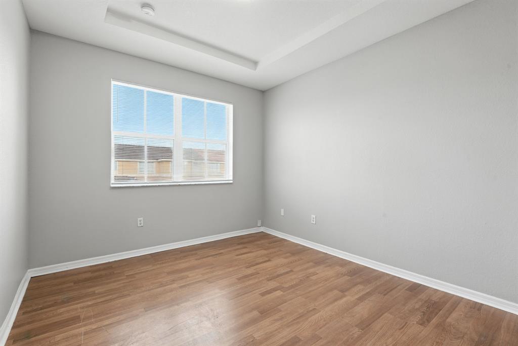 24055 Southwest 109th Court Homestead, FL 33032 - Photo 19 of 42 a view of empty room with wooden floor and fan