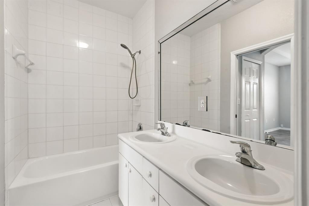 24055 Southwest 109th Court Homestead, FL 33032 - Photo 22 of 42 a bathroom with a sink a mirror and a bathtub