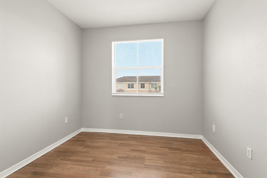 24055 Southwest 109th Court Homestead, FL 33032 - Photo 24 of 42 wooden floor in an empty room with a window
