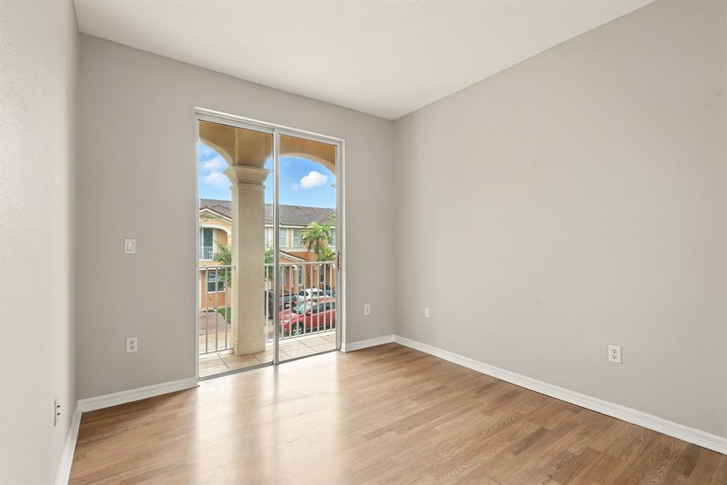 24055 Southwest 109th Court Homestead, FL 33032 - Photo 26 of 42 an empty room with wooden floor and door