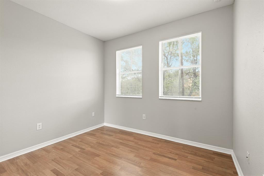 24055 Southwest 109th Court Homestead, FL 33032 - Photo 28 of 42 an empty room with wooden floor and windows