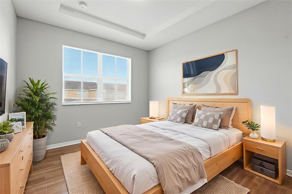 24055 Southwest 109th Court Homestead, FL 33032 - Photo 5 of 42 a bedroom with a bed and a potted plant