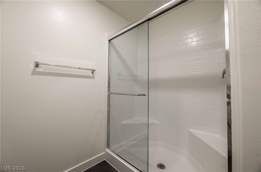 12749 Epperly Street Henderson, NV 89044 - Photo 13 of 22 A well-appointed shower stall features clean white subway tile and convenient built-in seating.