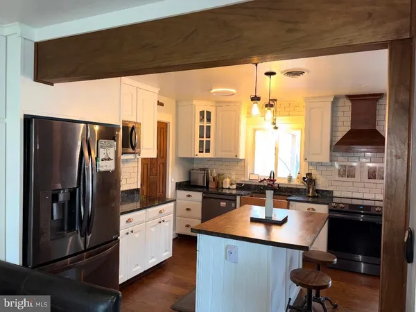 a kitchen with stainless steel appliances a sink stove and refrigerator