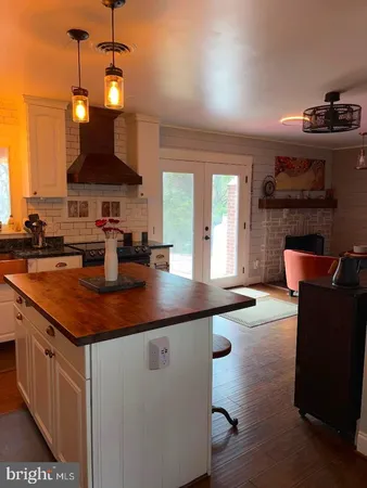 a kitchen with a sink a counter space and cabinets