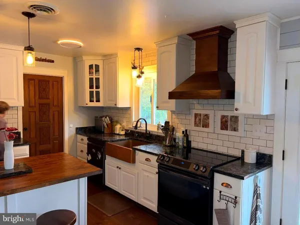 a kitchen with a stove and a sink