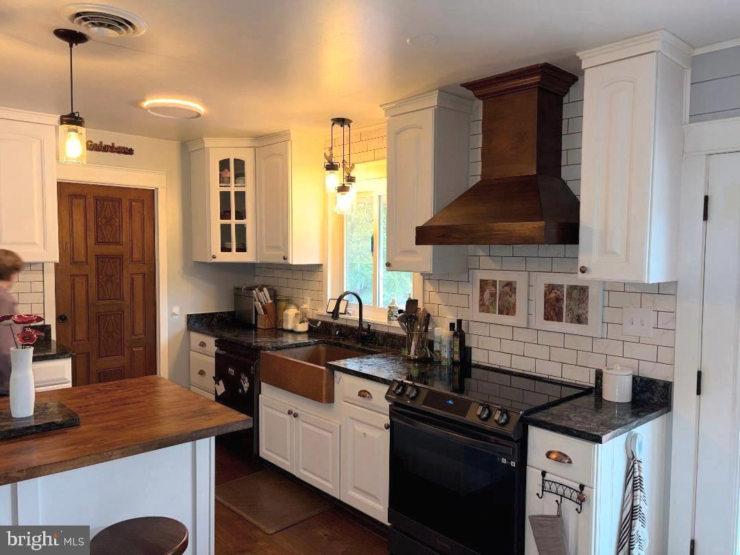 2615 Whitt Road Kingsville, MD 21087 - Photo 36 of 45 a kitchen with stainless steel appliances granite countertop a stove a sink and a microwave