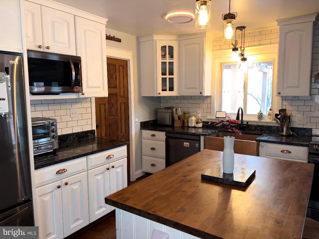 2615 Whitt Road Kingsville, MD 21087 - Photo 40 of 45 a kitchen with stainless steel appliances kitchen island granite countertop a sink dishwasher stove top oven and refrigerator with wooden floor
