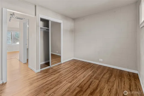 a view of an empty room with wooden floor