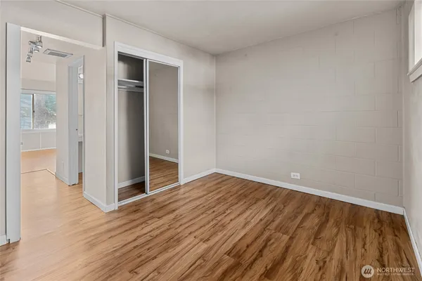 a view of an empty room with wooden floor
