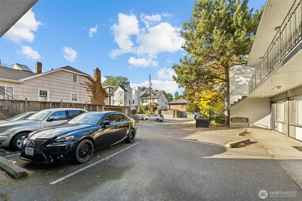 a view of a cars park in front of a building